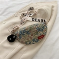 Retro floral tapestry crossbody chest bag with wide strap and plush pendant detail - Blue + Soot Sprite Charm