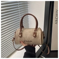 Close-up of beige suede Boston bag featuring brown leather handles and gold metal hardware - Off White