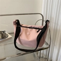 Pink minimalist nylon crossbody dumpling bag with black wide strap and circular logo - Pink