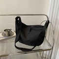 Chic black nylon crossbody dumpling bag with adjustable wide strap and matte finish - Black