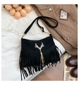 Detail of black matte bucket bag with gold deer head pendant and tassel on vintage lace - Black