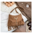 Detail of brown faux suede bucket bag featuring gold deer charm and bohemian tassels - Brown