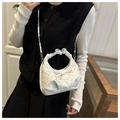 Detail of white lace shoulder bag with rhinestone bow and pleated handle worn by model - White Without Pendant