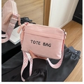 Pink corduroy tote bag detail with TOTE BAG embroidery and geometric patterned strap - Pink