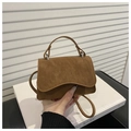 Detail of vintage brown textured leather handbag with silver twist lock and top handle - Brown