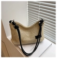 Detail of beige woven straw shoulder bag featuring black rope straps and silver hardware - Black