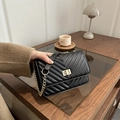 Classic black quilted chain crossbody bag with V-pattern and gold-tone twist lock - Black
