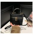 Detailed view of black crocodile pattern box bag with golden zippers and rigid handle - Black