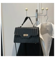 Detail of black woven leather handbag with gold twist lock and fine shoulder strap - Black