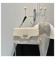 Detail of cream woven leather handbag with twist lock closure and top handle - White