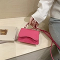 Mini hot pink glossy leather handbag with wavy flap and crossbody shoulder strap - Pink