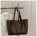 Detail of dark brown tote bag with smooth faux leather and silver metal rivet accents - Brown