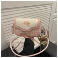 Detail of pink plaid crossbody bag with a cute bear charm and polka dot flap design - Sakura Pink (With Teddy Bear Charm)