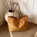 Caramel large capacity tote bag in matte suede style placed in a minimalist setting - Brown