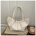 Macro view of creamy white pleated cloud bag with soft PU leather texture and hand strap - White