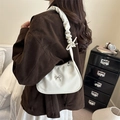 White crescent underarm bag with ruffled shoulder strap and silver bow detail - White