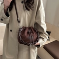 Dark brown drawstring bucket bag in suede finish with woven leather trim and thin strap - Brown