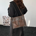 Stylish leopard print tote bag featuring double buckled front pockets and brown trim - Leopard Print Grey