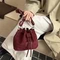 Burgundy drawstring bucket bag with knotted handle and textured matte finish suede - Red