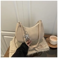 Macro detail of beige hobo bag with a silver butterfly pendant and beaded charm decoration - Khaki with Pendant