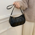 Minimalist black crescent shoulder bag with geometric quilted pattern and gold hardware - Black