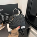 Vintage schwarze Muschel-Handtasche mit Stickerei und goldener Hardware in Lifestyle-Szene - Schwarz