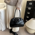 Glossy black patent leather shoulder bag with chic bow accent and golden lettering - Black