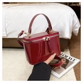 Detail of burgundy patent leather box bag with gold-tone hardware and wide handle - Red