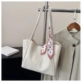 Detail of cream tote bag featuring a decorative polka dot scarf and premium PU leather texture - Off White