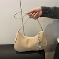 Beige suede hobo bag with rhinestone bow charm and slim shoulder strap - With Charm / Khaki