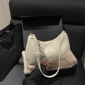 Minimalist beige glossy leather shoulder bag with a silver beaded bow charm in a gift box - White
