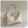 Macro detail of creamy white hobo tote bag showing soft textured leather and silver buckle - No Pendant / Off White