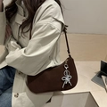 Dark brown suede shoulder bag with beaded bow charm paired with a light trench coat - With Charm / Brown