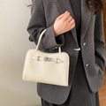 Detail of cream rectangle handbag with lychee leather texture and metal turn-lock - No Pendant / White