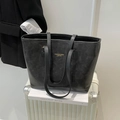 Minimalist black leather tote bag with gold lettering on white luggage for travel - Black