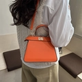Vibrant orange trapezoid handbag with metallic twist lock and top handle strap - Orange