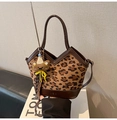 Detailed view of leopard print canvas bag with brown leather stitching and bear charm - Brown with Pendant
