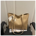 Detail of beige tote bag with soft leather texture and stylish floral silk scarf accessory - Khaki
