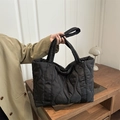 Black quilted puffer tote bag with wave stitching and spacious shoulder straps - Black