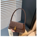 Detail of vintage dark brown underarm bag with frosted leather and gold turn-lock - Coffee