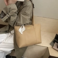 Khaki large capacity leather tote bag with silk scarf charm shown on shoulder - Khaki