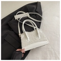 Macro shot of white plush fleece tote bag with PU leather trim and gold metal hardware - White