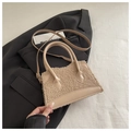 Detail of soft beige faux shearling handbag with leather handle on black blazer - Dark Khaki