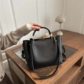 Minimalist black lychee texture leather tote bag for women showing a lifestyle view - Black