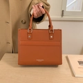 Chic orange faux leather tote bag with pebble texture and sturdy top handles - Brown