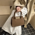 Fashionable caramel matte suede handbag with gold lock shown in lifestyle outfit view - Khaki