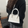 White lamb wool crossbody bag with leather trim and gold hardware on model - White