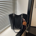 Chic black faux leather tote bag with slim shoulder straps and a brown teddy bear charm - Black (With Pendant)