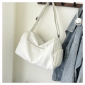 Detailed view of the white sports duffel bag with zipper pockets hanging on a wooden hook - Off White