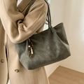 Detail of green leather tote bag with vintage wood bead tassel on wool coat - Green With Wood Bead Pendant